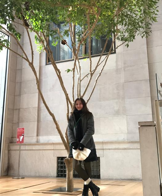 Jenna Tuckerman Standing Under Tree In Courtyard